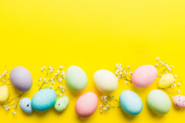 istock Happy Easter composition. Easter eggs on colored table with gypsophila. Natural dyed colorful eggs background top view with copy space 2147718471