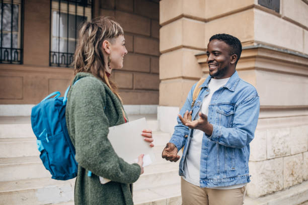 istock Smiling college students chatting outdoors 2147718793