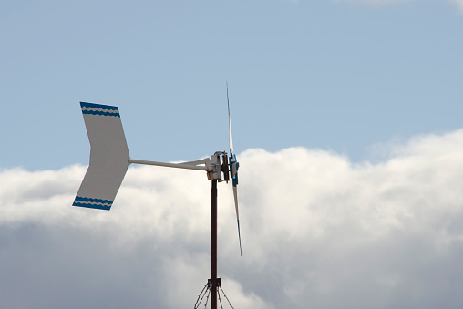 home wind turbine, clean electric energy with blue sky in the background