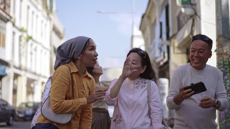 Asian tour guide cruising around city of Penang