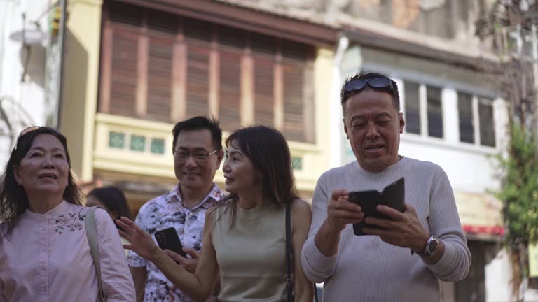 Asian tour guide taking photos of tourist