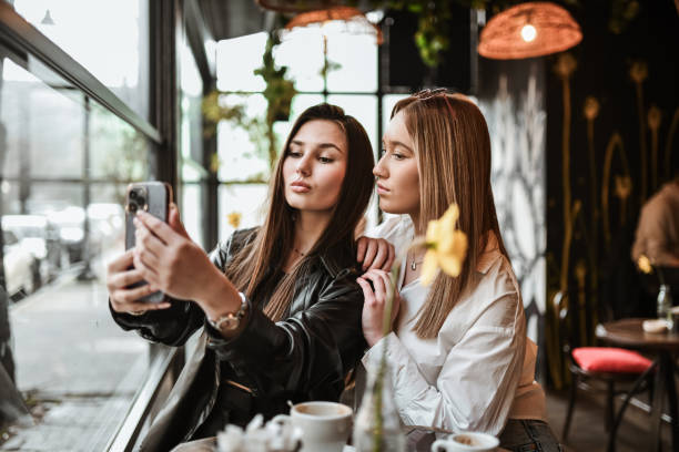 istock Females Taking Cute Selfie While Enjoying Coffee 2147721991