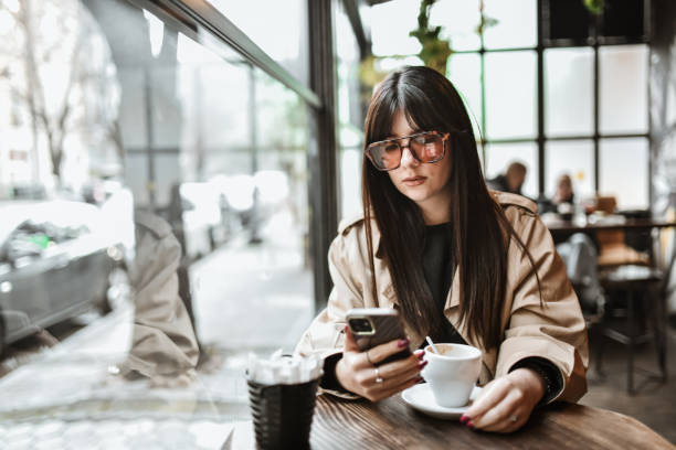 istock Female Texting Via Smartphone While Drinking Coffee In Bar 2147722423