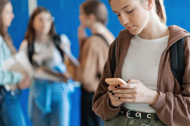 istock Portrait of female high school student using phone 2147723036