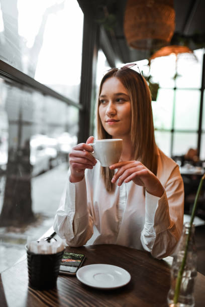 istock Day Dreaming Time For Cute Female Drinking Coffee In Bar 2147723393