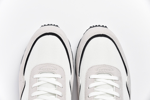 Pair of white male sneakers shoes with lacing top view on white background