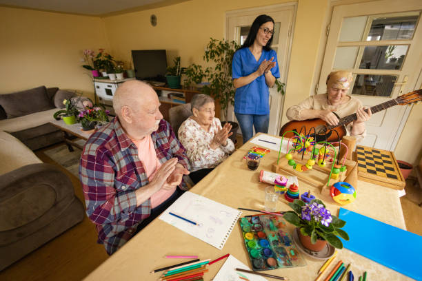 istock Elderly Lady's Guitar Performance in Group Therapy 2147871272