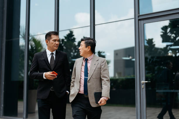 istock Mature Asian businessmen having discussion in modern office park 2148022894