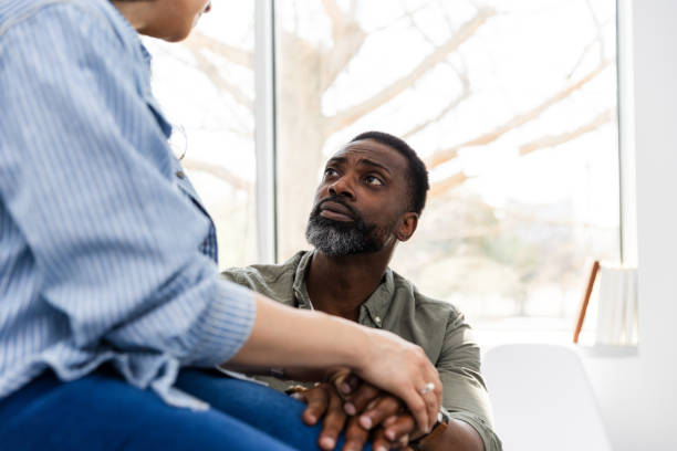 istock In doctor's office, husband looks up at unrecognizable wife 2148023084