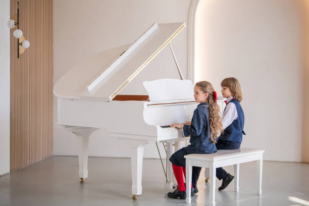 istock Two children are playing the piano. 2148023813