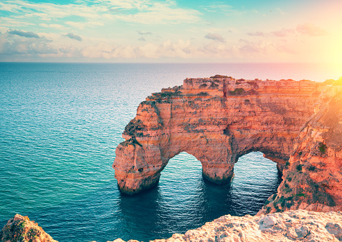 Two arches in the rock. Rock Elephant drinks water. View of Praia da Marinha and Benagil beach in the Algarve region of the Atlantic Ocean, Portugal