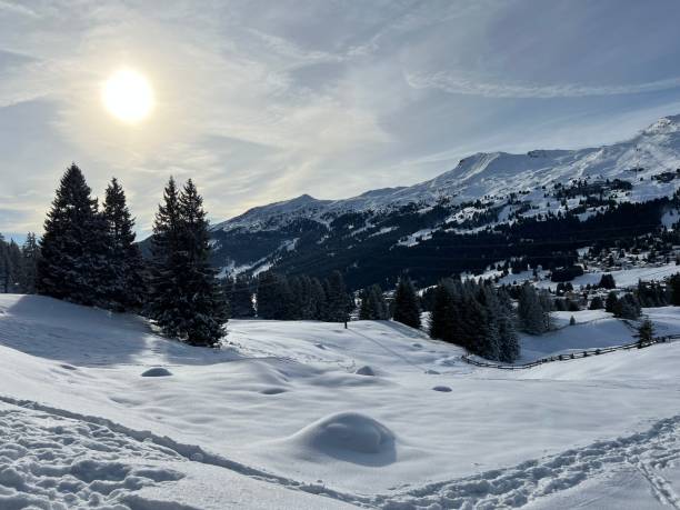Beautiful sunlit and snow-capped alpine peaks above the Swiss tourist sports-recreational winter resorts of Valbella and Lenzerheide in the Swiss Alps - Canton of Grisons, Switzerland (Schweiz) stock photo