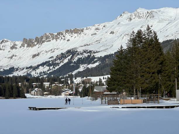 Beautiful sunlit and snow-capped alpine peaks above the Swiss tourist sports-recreational winter resorts of Valbella and Lenzerheide in the Swiss Alps - Canton of Grisons, Switzerland (Schweiz) stock photo