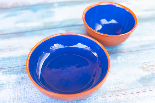 Two vinrant blue empty Mallorquin ceramic bowls as a mockup for your food. Part of a series.