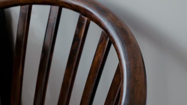 Restoration of a wooden chair. Covering with dark varnish. Close-up. Vintage things.