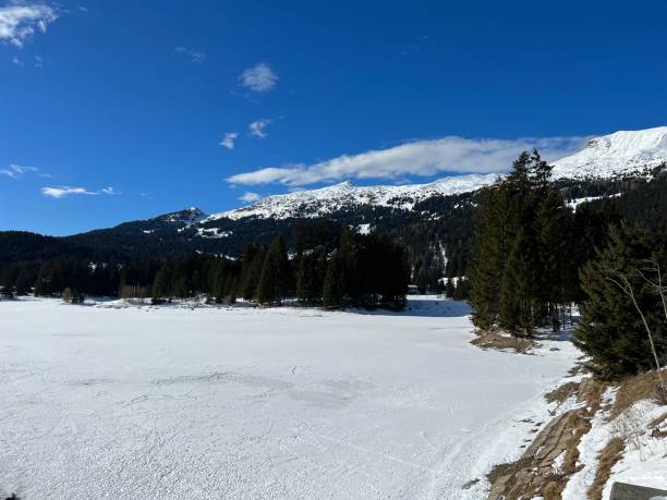 A typical winter idyll on the frozen and snow-covered alpine lake Heidsee (Igl Lai) in the Swiss winter resorts of Valbella and Lenzerheide - Canton of Grisons, Switzerland (Schweiz) stock photo