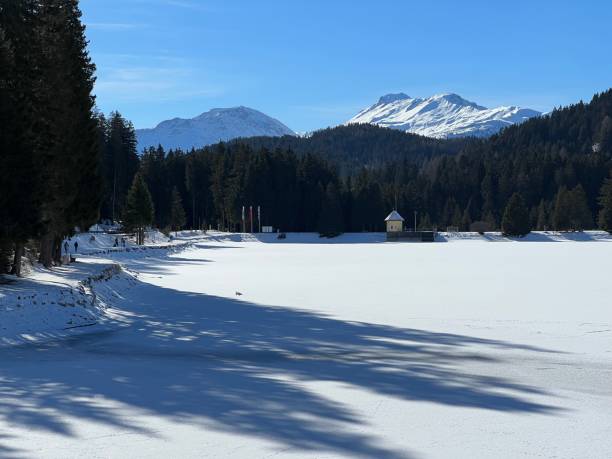 A typical winter idyll on the frozen and snow-covered alpine lake Heidsee (Igl Lai) in the Swiss winter resorts of Valbella and Lenzerheide - Canton of Grisons, Switzerland (Schweiz) stock photo