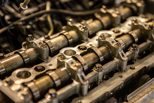 A detailed close-up of a cylinder within a car engine, showcasing the intricate components and machinery at work.