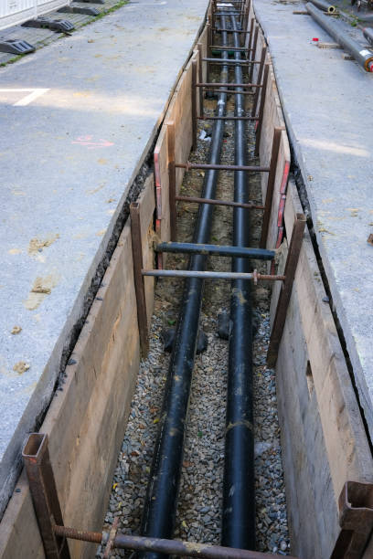 istock Road construction site with excavated trench 2148028675