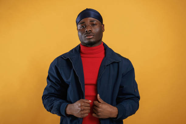 istock Serious facial expression. Handsome black man is in the studio against yellow background 2148029227