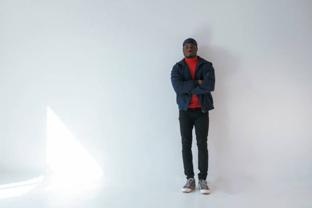 istock Posing with arms crossed. Black man in cap is in the studio against white background 2148030004