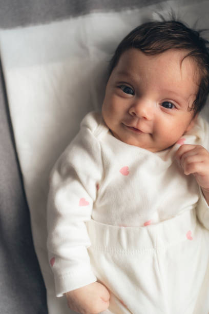 istock Smiling newborn baby in bed 2148030478