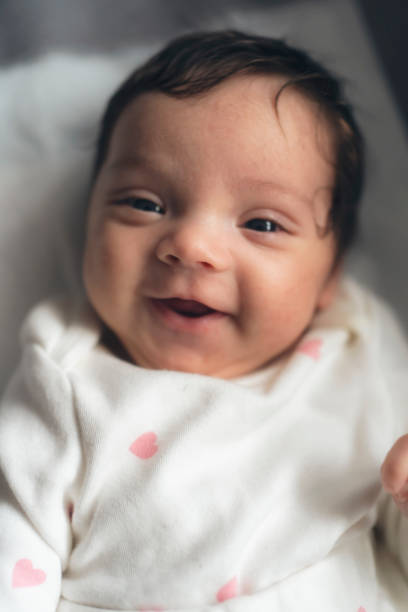 istock Smiling newborn baby in bed 2148030489