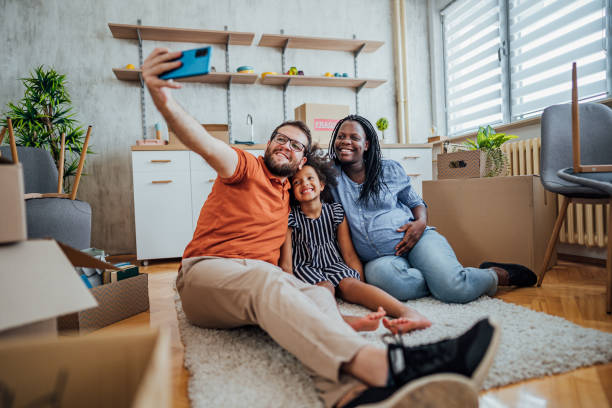 istock Multi-ethnic family making selfies in their new home 2148031075