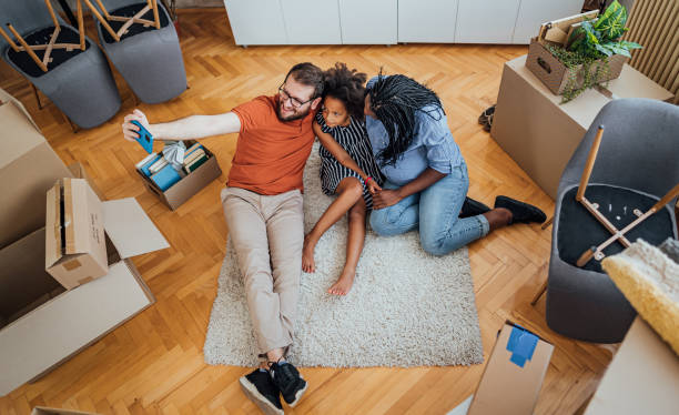 istock Multi-ethnic family making selfies in their new home 2148031214