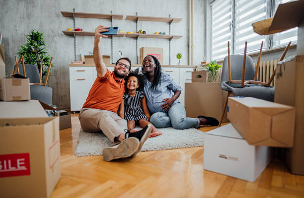 istock Multi-ethnic family making selfies in their new home 2148031322
