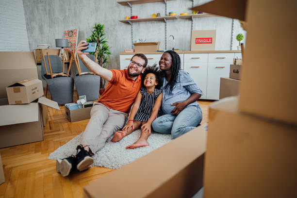 istock Multi-ethnic family making selfies in their new home 2148031734