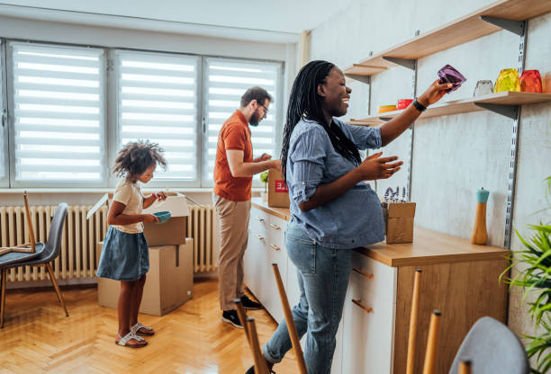 istock Family unpacking cardboard boxes at new home 2148031945