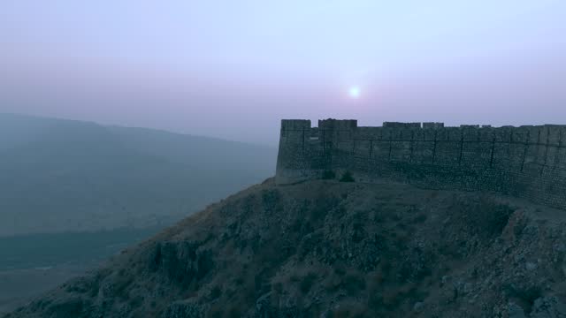 Aerial Profile view of Ranikot Fort (Great wall of Sindh) with foggy landscape at background.