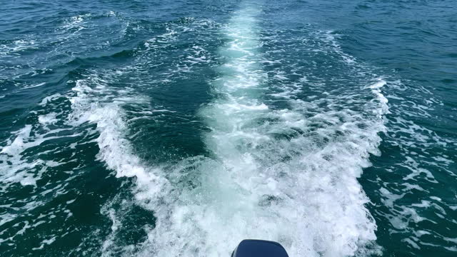 Trail on the water behind the fast moving motor boat Goa India