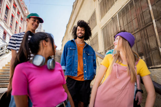 istock Young friends talking while walking down a staircase outdoors 2148033657