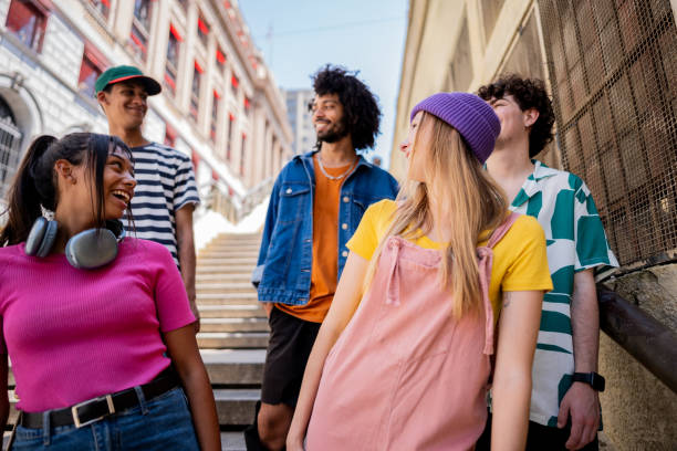 istock Young friends talking while walking down a staircase outdoors 2148033660