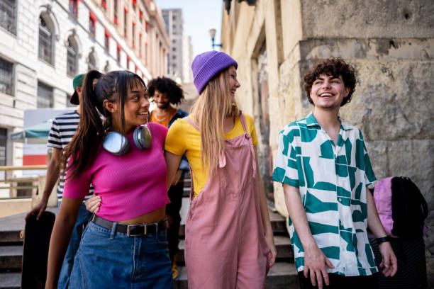istock Young friends talking while walking down a staircase outdoors 2148033681