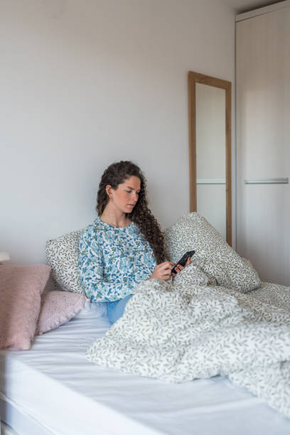istock Woman using smartphone in the bed 2148033704