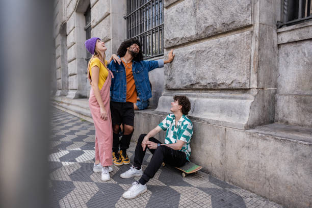 istock Young friends talking at city street 2148033821