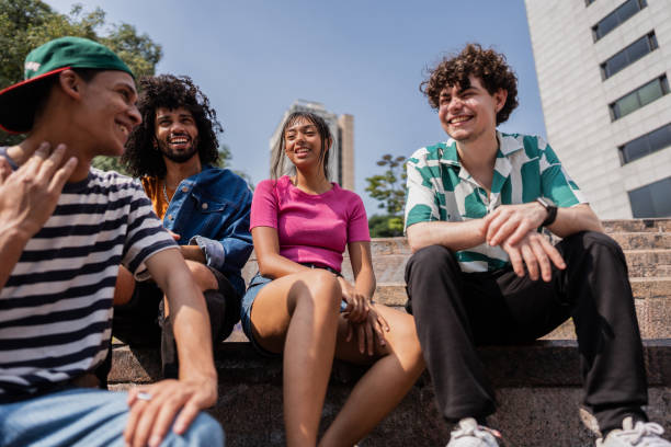 istock Young friends talking sitting on staircase outdoors 2148033894