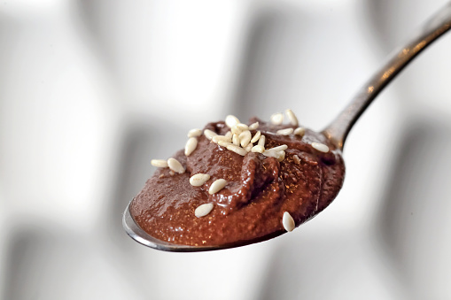 chocolate cream with sesame on spoon