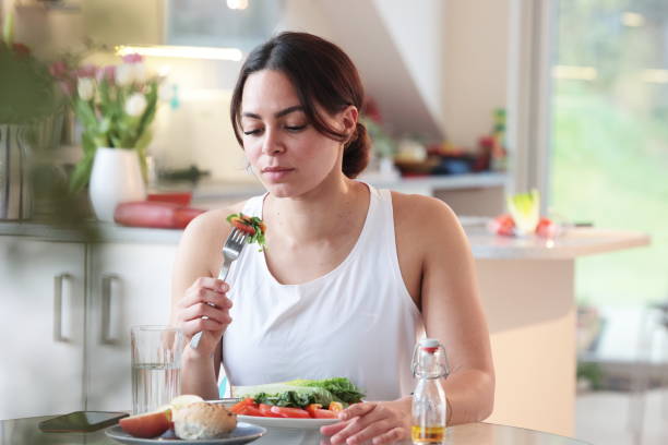 istock Multiracial woman eats salad 2148036580