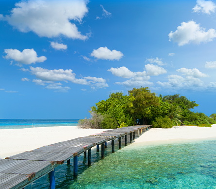 Boardwalk across turquoise sea and white beaches