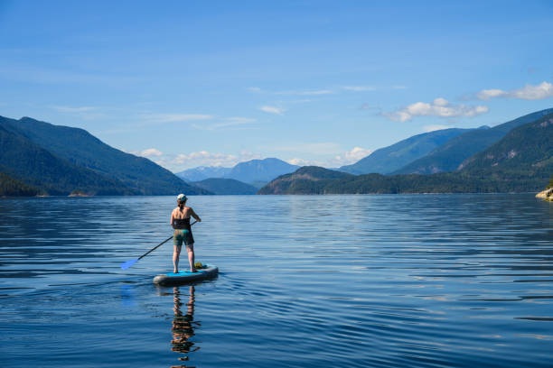 istock Woman paddle boards on ocean 2148036951