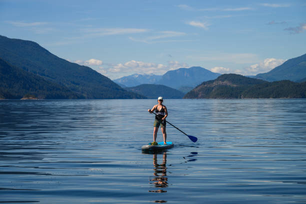 istock Woman paddle boards on ocean 2148036998