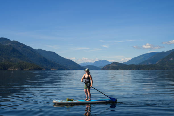 istock Woman paddle boards on ocean 2148037039