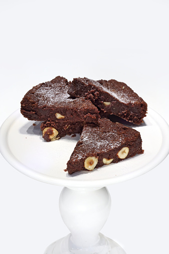 Chocolate brownie with chestnuts on plate