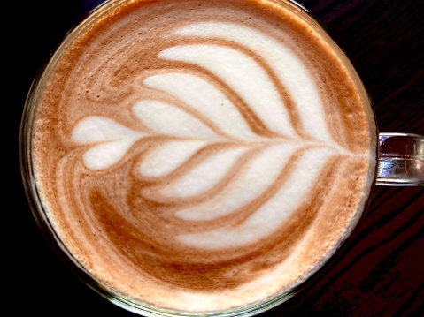 Coffee froth art against a dark background
