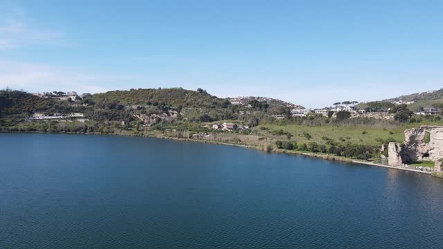 Lake in south of italyDiscover the tranquil beauty of a Southern Italian lake captured from above by a drone: serene waters, lush greenery, and quaint lakeside villages create a mesmerizing vista.