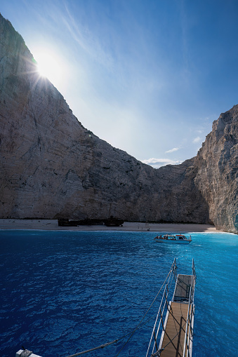 Panoramic view of the famous Navagio shipwreck beach on Zakynthos island, Greece, with people enjoying the light blue colored sea